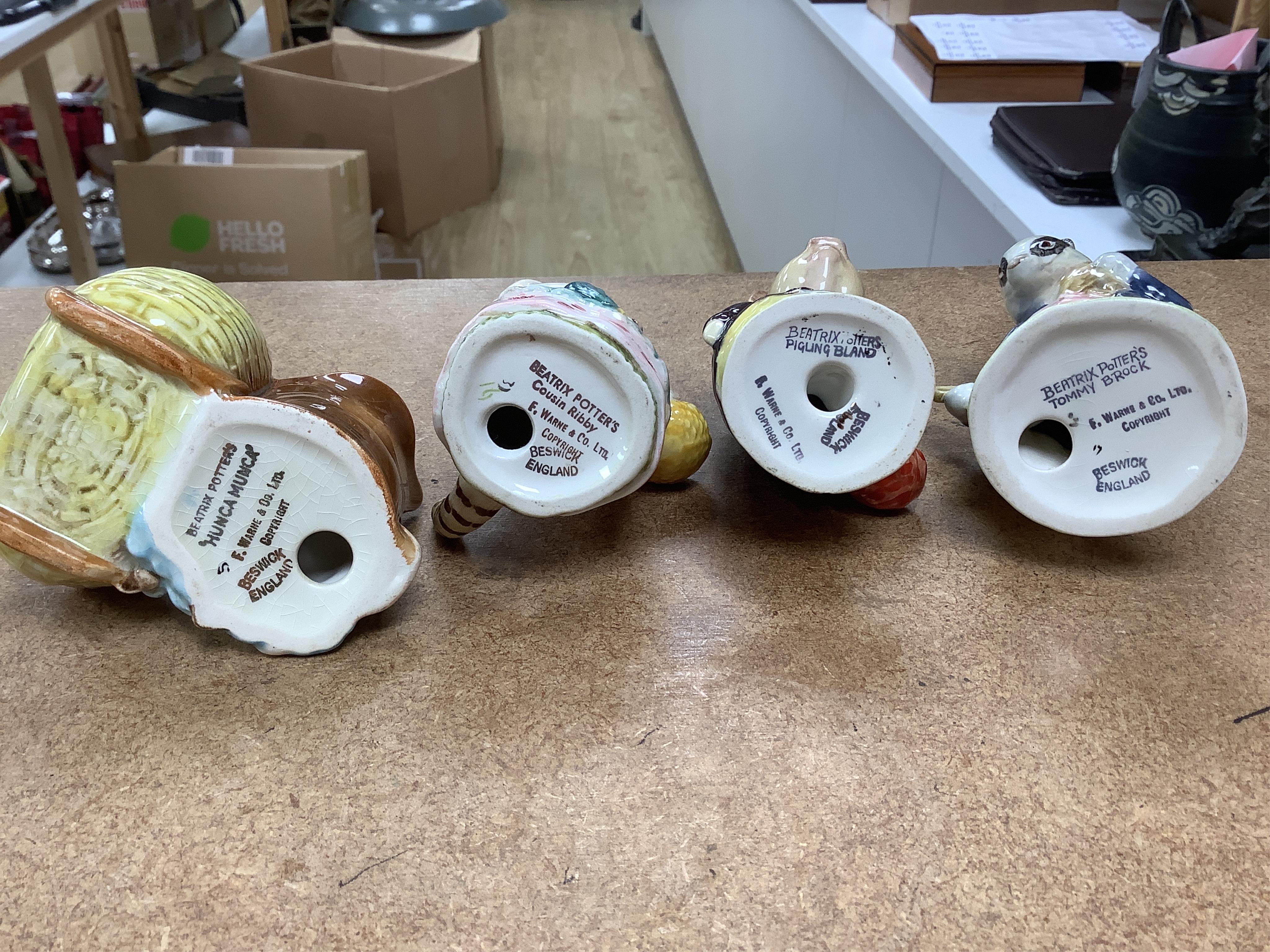 A collection of thirteen Beatrix Potter character figures, stamped with a gold stamp F Warne and Co Ltd, Beswick England, largest 12cm high